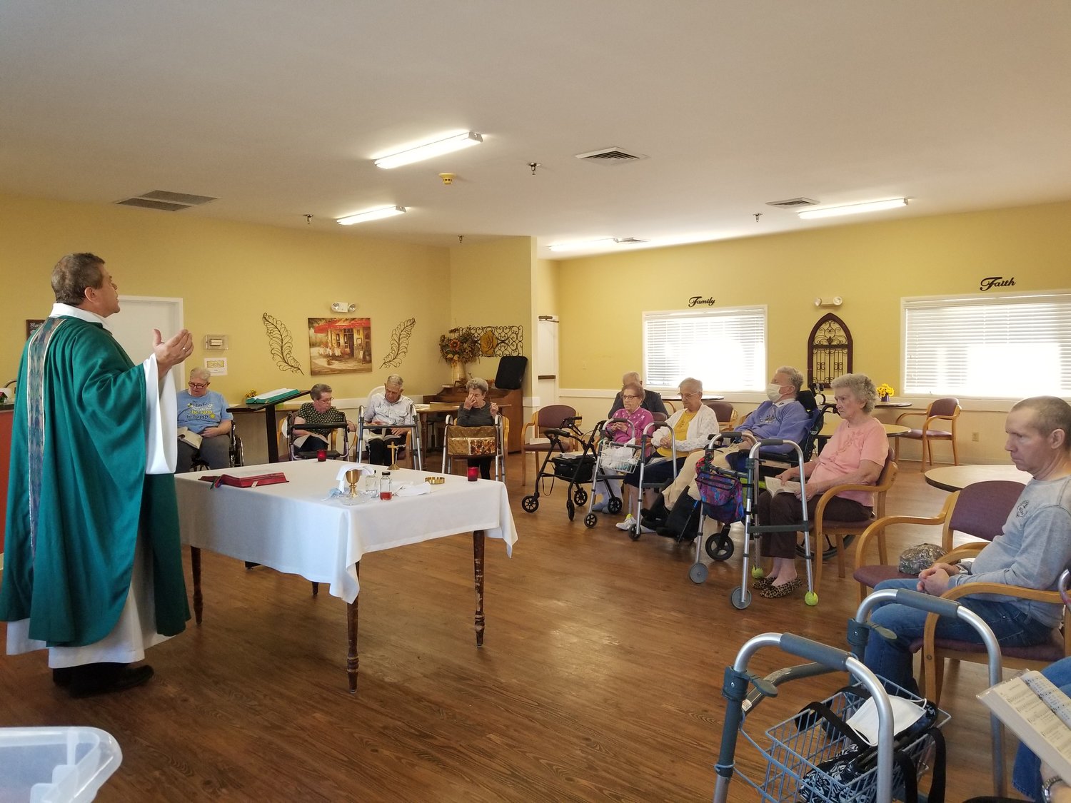 Father Gregory Oligschlaeger, pastor of Holy Rosary Parish in Monroe City and St. Stephen Parish in Indian Creek, offers Mass in a local senior living center.